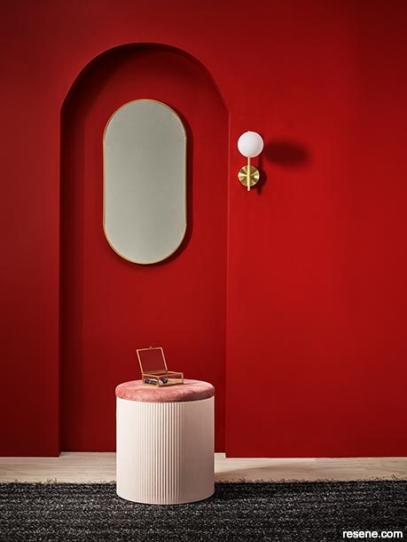 Whitewashed timber floors contrasts with bright red walls