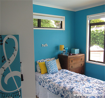 A blue and white room with yellow accents for a teen age girl
