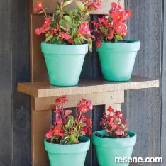 Make some simple outdoor shelves for displaying potted plants