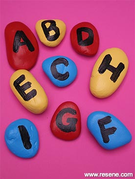 Paint stones with letters