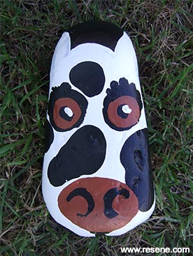 Paint a cow on a rock