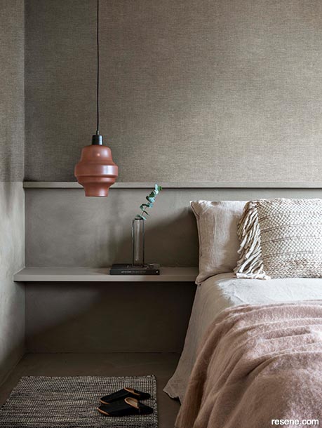 A minimalist bedroom with textured wallpaper