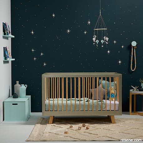 A nursery with a starry sky mural