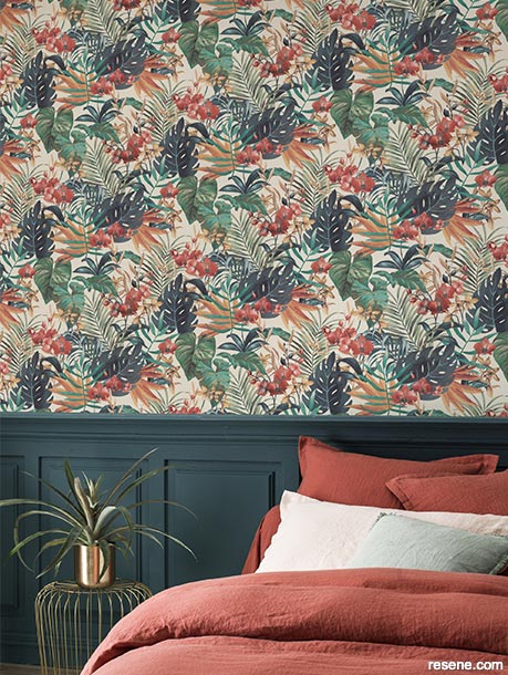 A bedroom with leaf print wallpaper
