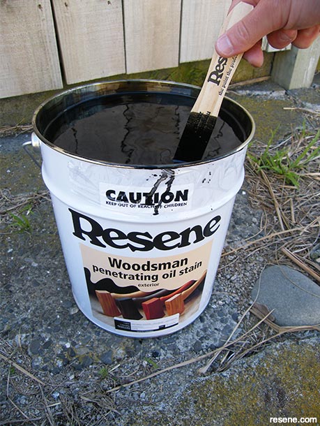 Stain your fence - stir paint and stains