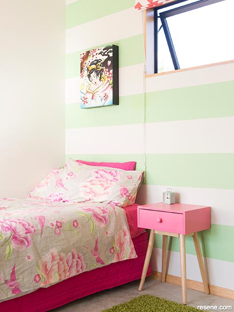 A kids bedroom with pastel stripes