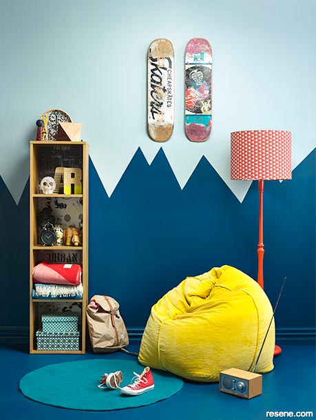 A teen bedroom with a mountain paint detail