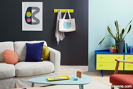 A colourful lounge with a piece of statement artwork
