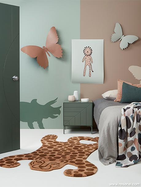 A green and brown room with butterfly and dinosaur decorations