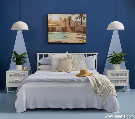 A dramatic blue master bedroom