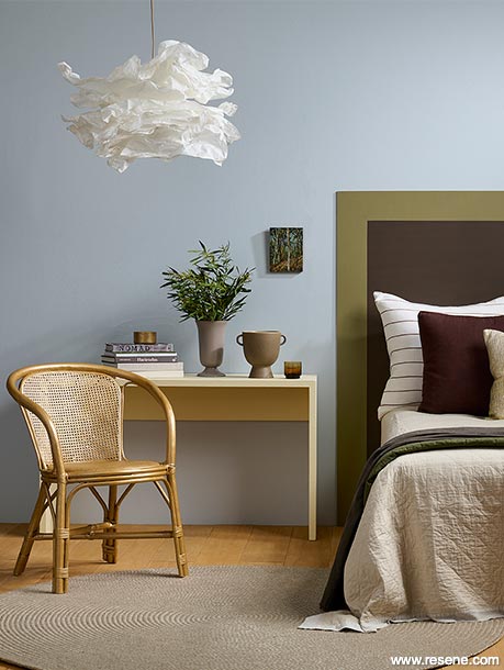 A grey bedroom with a colourful headboard