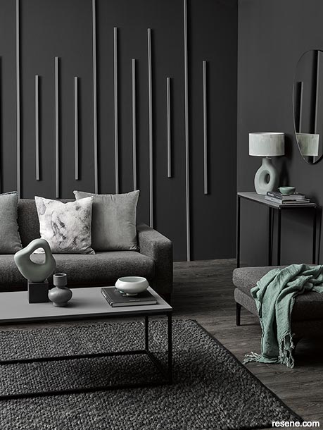 A dark luxurious soft black lounge with green accents