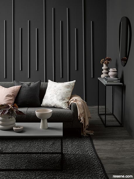 A dark luxurious soft black lounge with pink accents