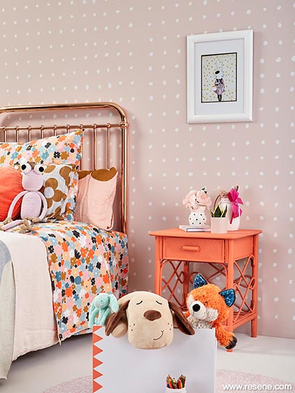 Bedroom with an unexpected vibrant coral bedside table