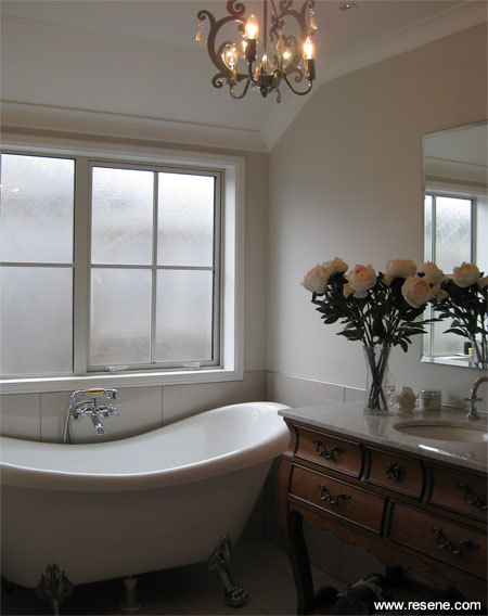 The same simple colour scheme of Resene White Pointer and Resene Alabaster is carried through to the bathroom