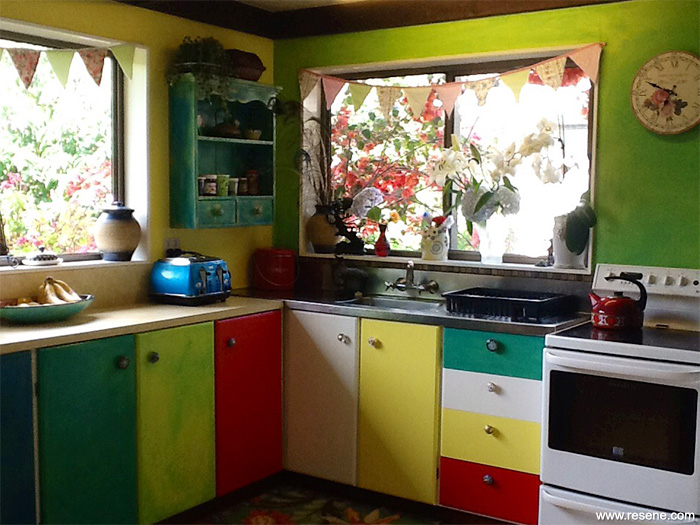 Kitchen with vibrant cuppboard doors