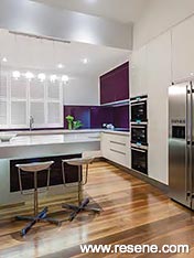 A white kitchen with colourful detailing.