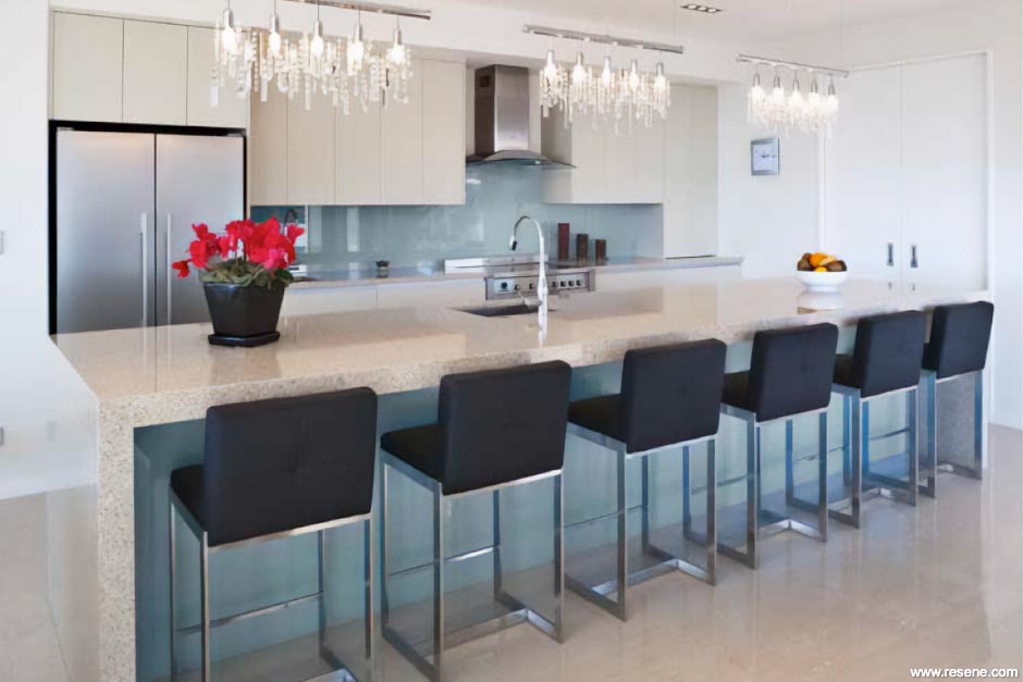 A painted glass splashback and island feature in Resene Coastal Blue