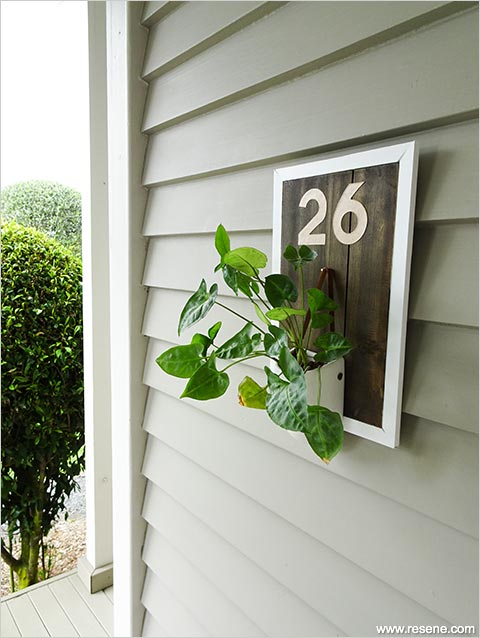 House number with pot plant