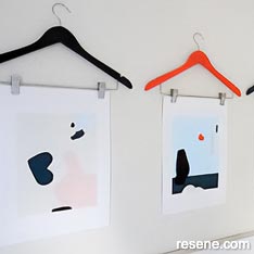 Paint coat hangers to display your own abstract art