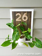 Make a rustic house number with potted plant