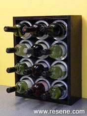 Wine bottle rack made from recycled paint cans