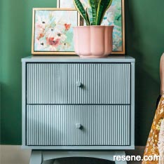 Update your bedside table with a coat of paint and wallpaper lined drawers