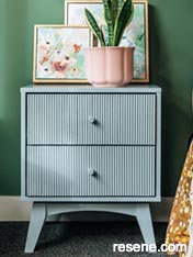 Update your bedside table with a coat of paint and wallpaper lined drawers